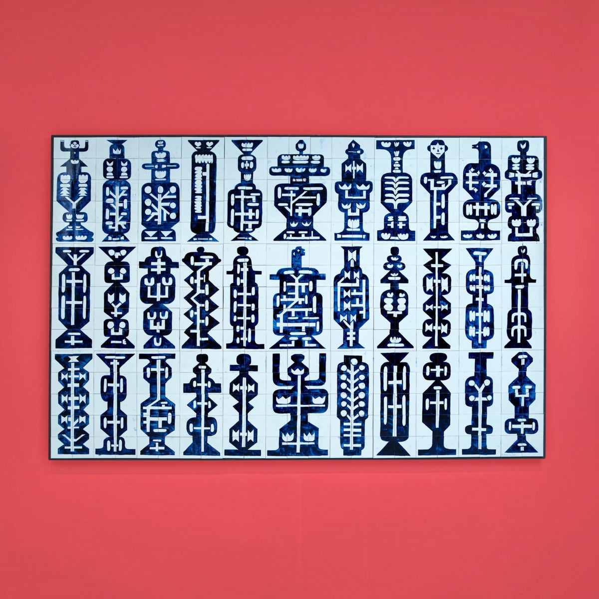 Royal Delft hand-painted ceramic tile tableau featuring 345 unique blue totem patterns on a vibrant red wall.