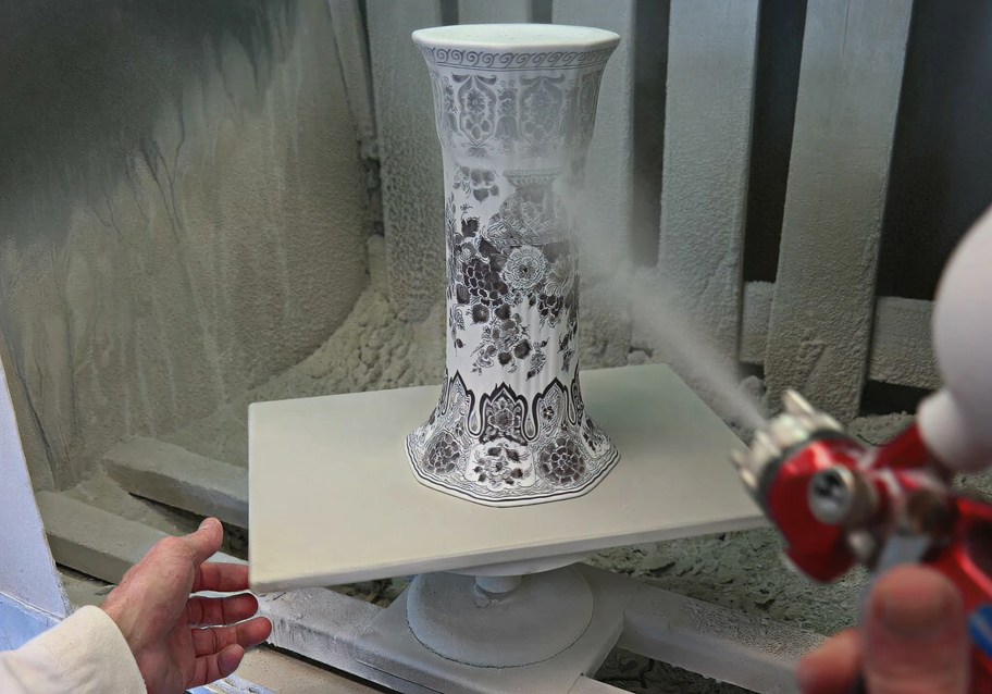 Royal Delft vase being glaze-sprayed before firing